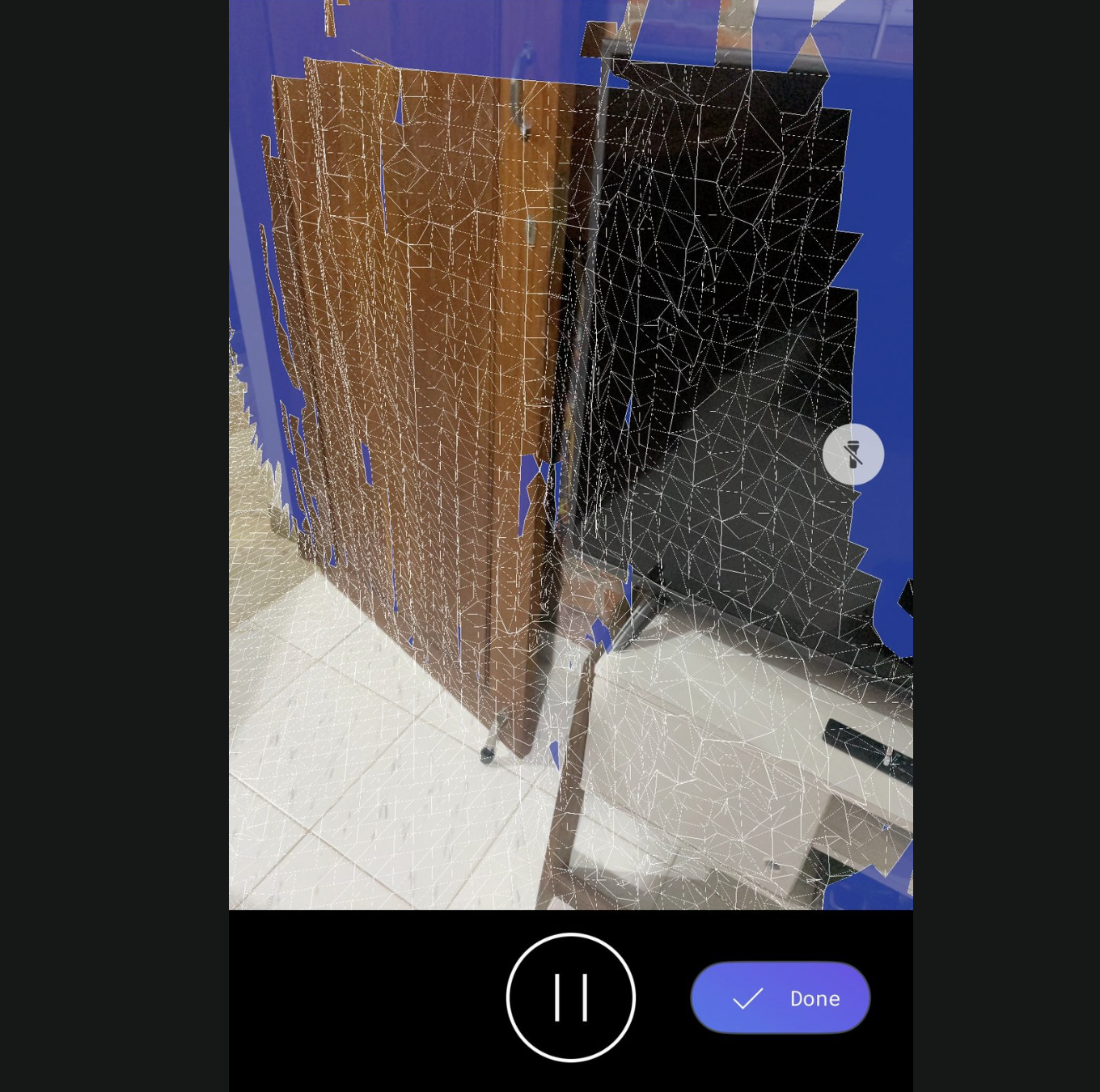 A phone screen mid-scan — a shimmering white wireframe overlaid on a wooden wardrobe and a black cabinet